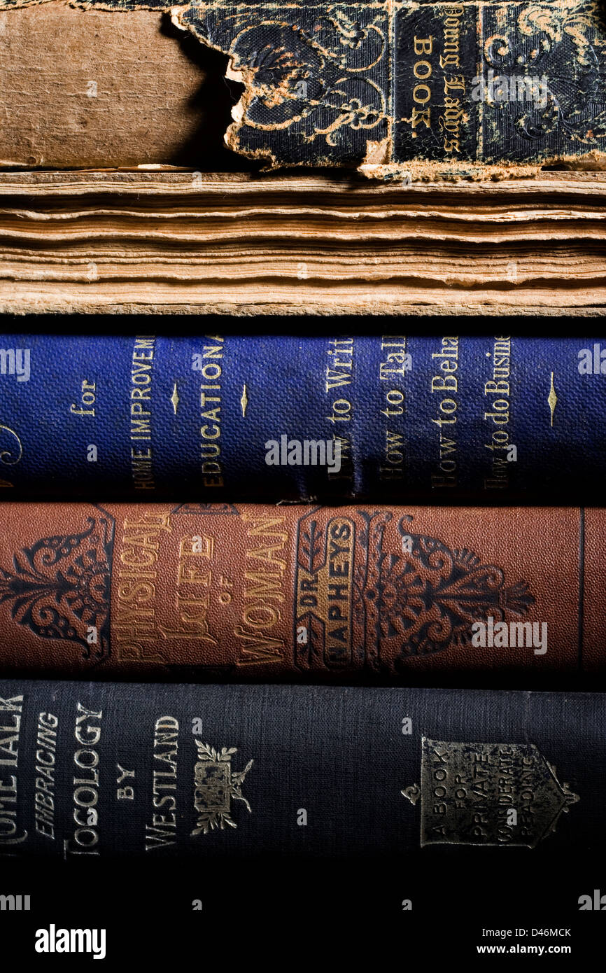 A stack of antique books sit on a shelf Stock Photo Alamy