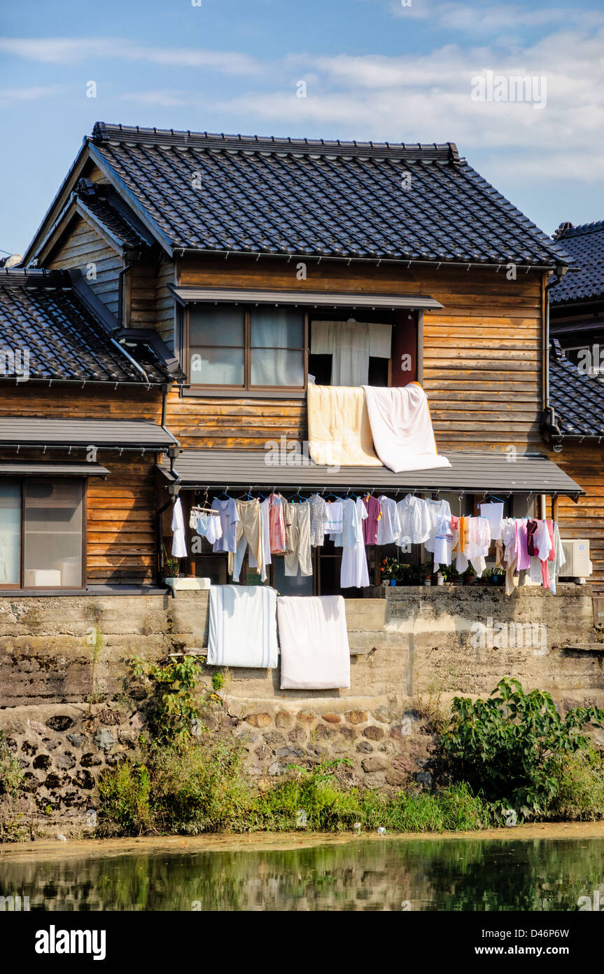 Laundry day in Japan hanging the washing out from the windows of a
