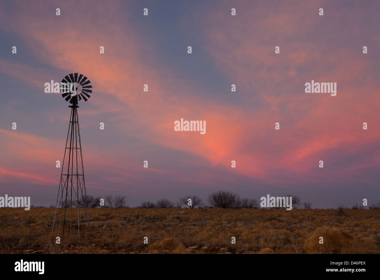 Old windmill at sunset in west Texas Stock Photo