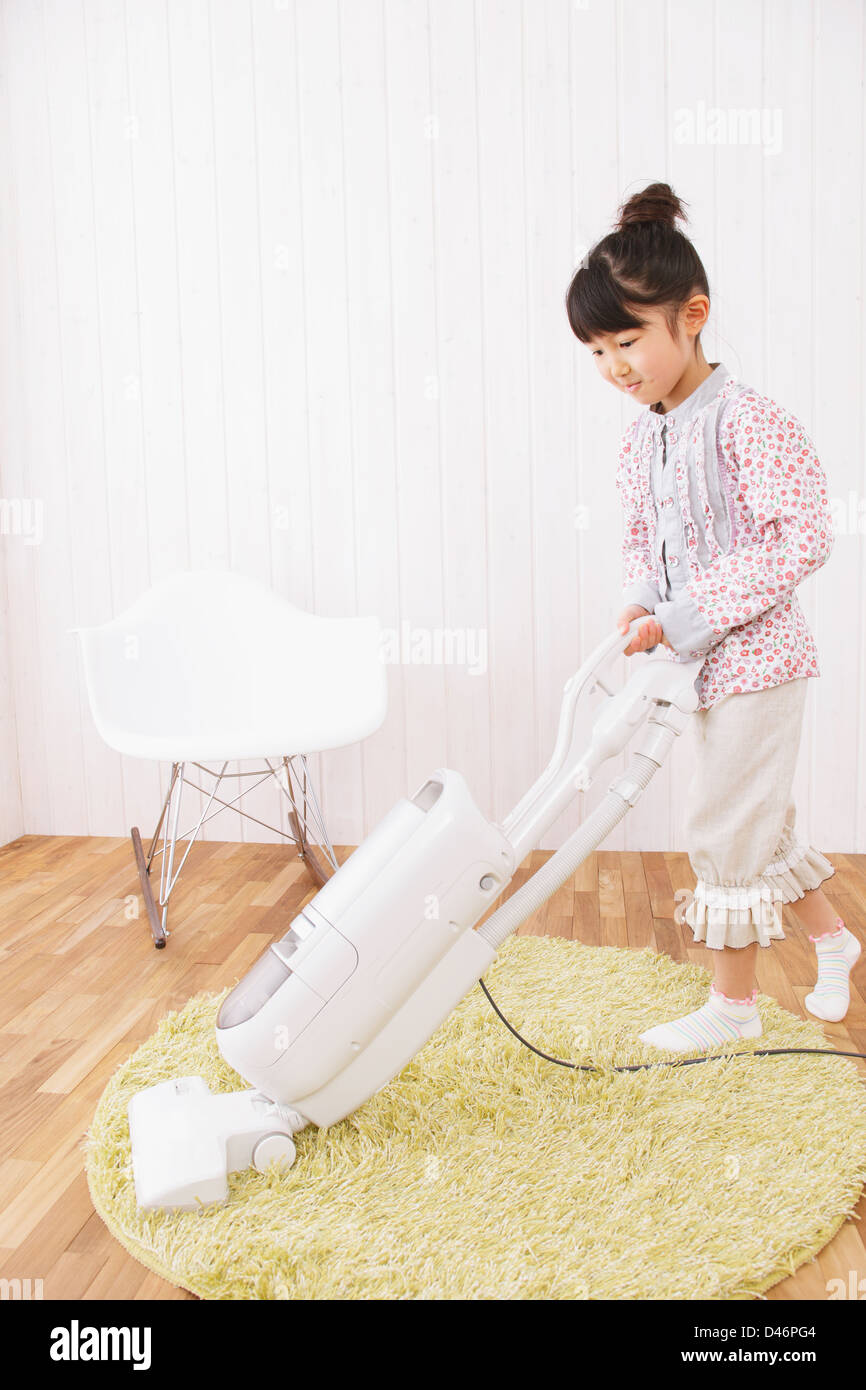 Girl Vacuuming a Carpet Stock Photo - Alamy
