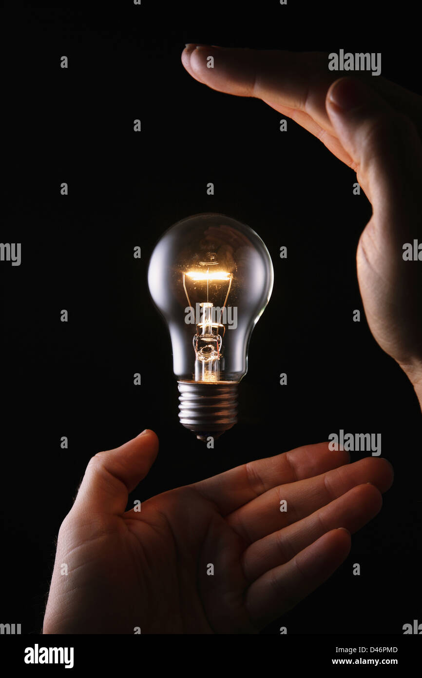 Hands With Light Bulb Stock Photo Alamy