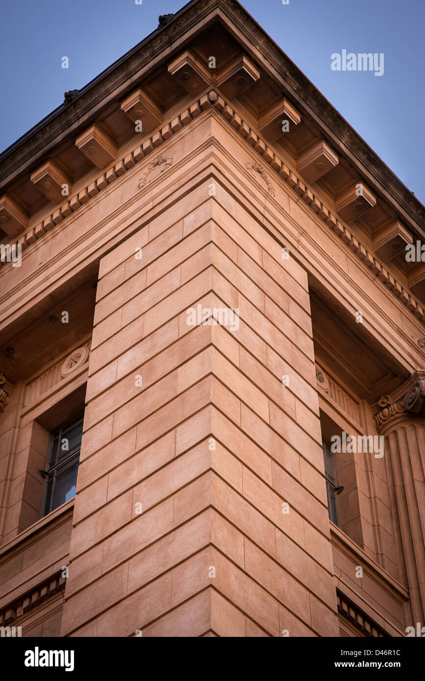 An abstract of a sandstone building corner against the clear blue sky Stock Photo