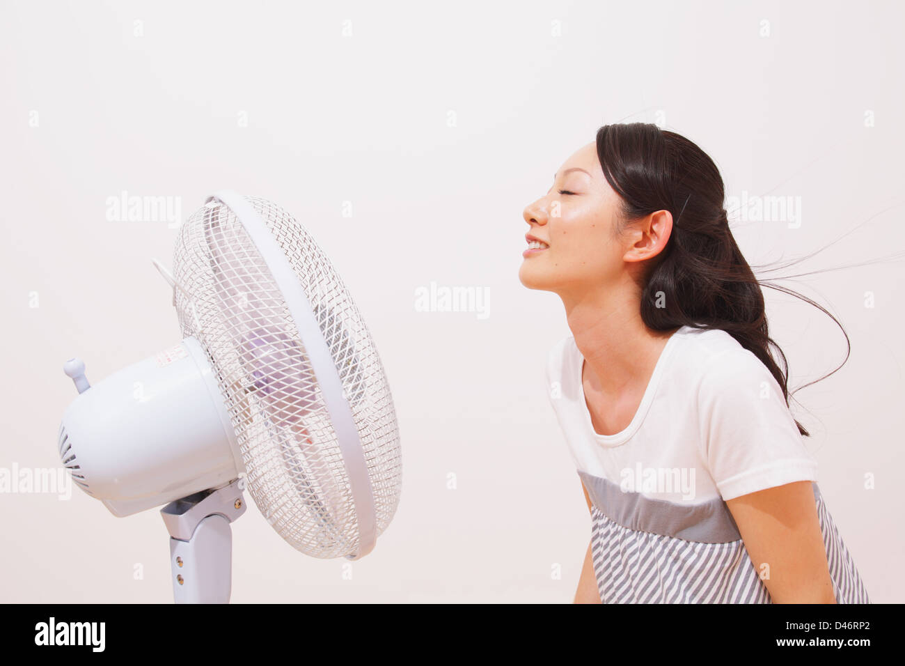 Woman cooling down fan hi-res stock photography and images - Alamy