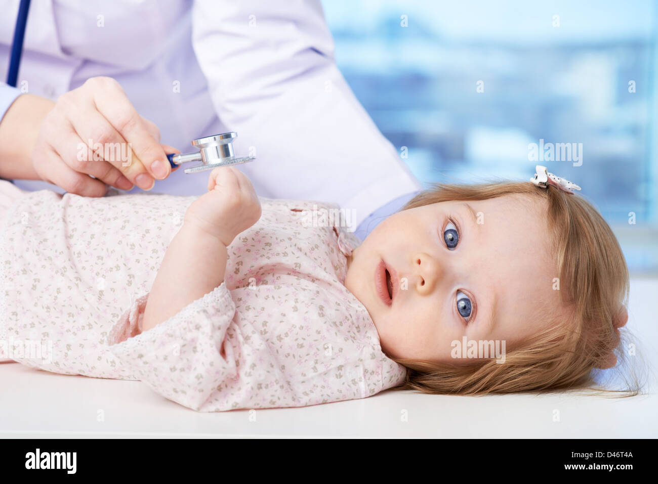 Cute baby being examined by pediatrician Stock Photo