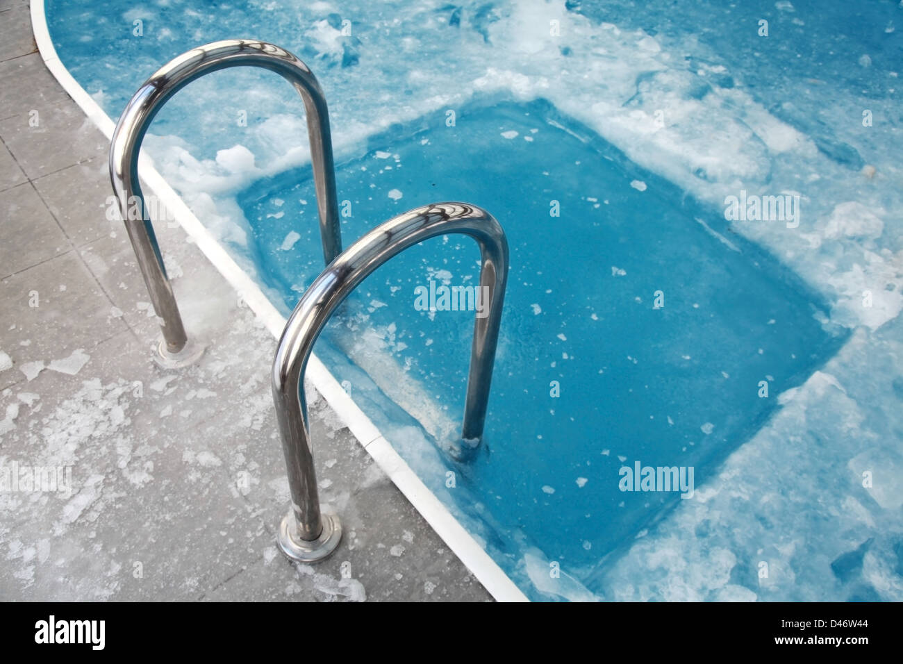 Ice swimming theme. Steps in the frozen blue pool ice-hole Stock Photo