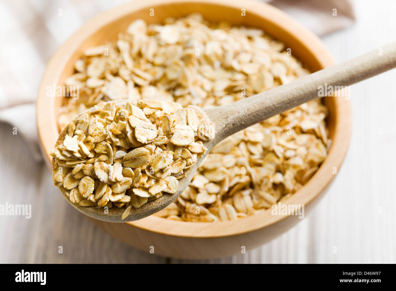 the oat flakes on a wooden spoon Stock Photo