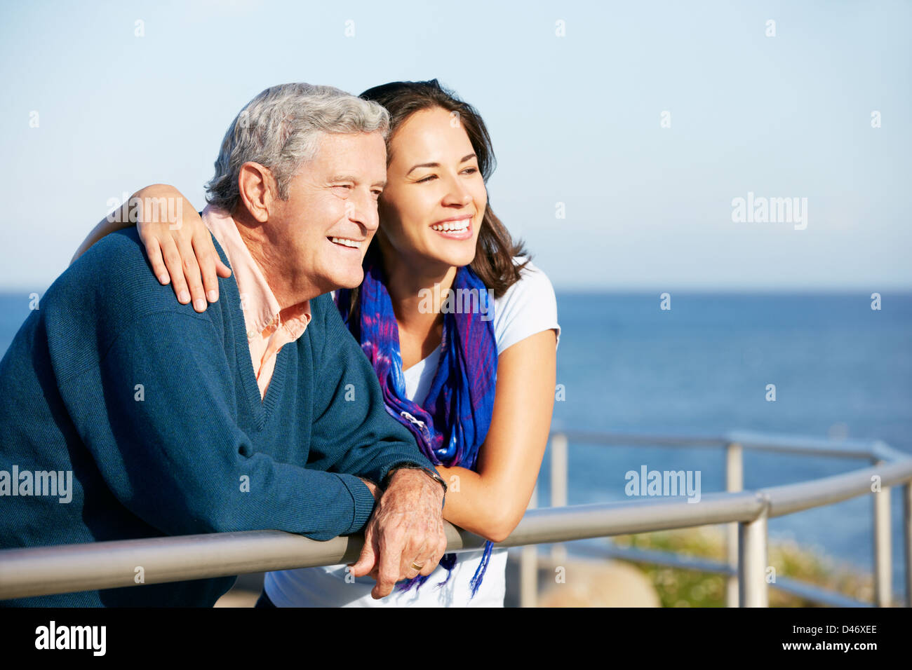 Senior Man With Adult Daughter Looking Over Railing At Sea Stock Photo ...