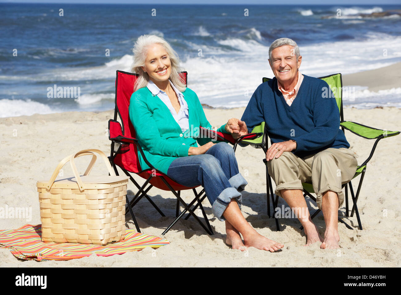 Couple sitting in deckchairs on the beach hi-res stock photography and ...