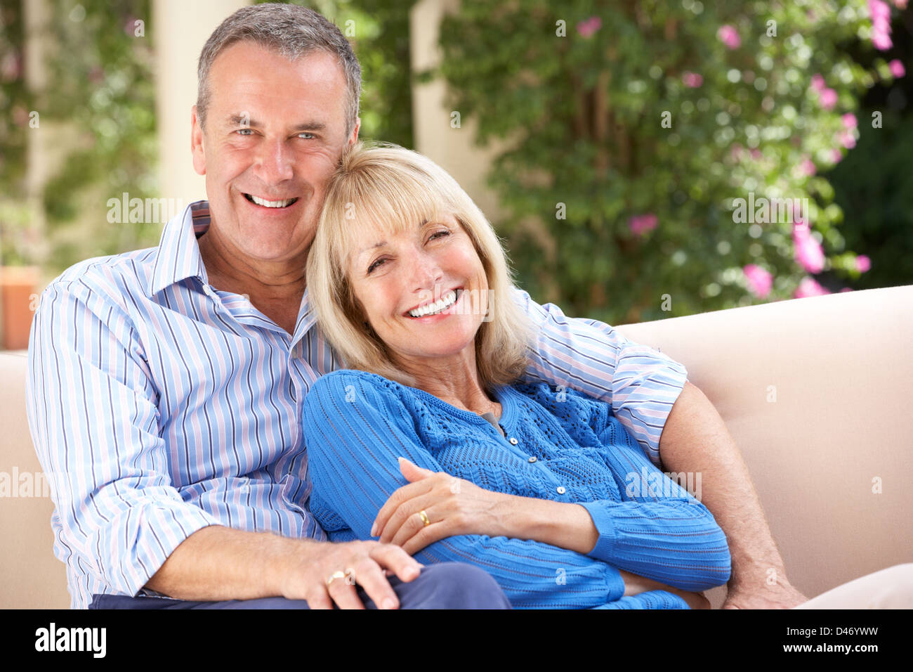 Senior Couple Relaxing On Sofa At Home Stock Photo - Alamy