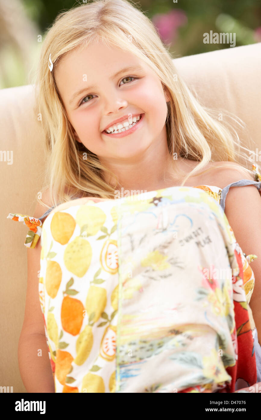 Happy Girl Sitting On Sofa Stock Photo - Alamy