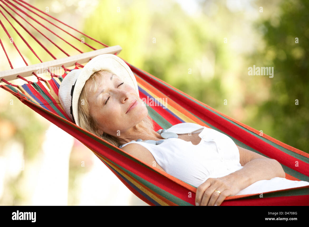 Senior Woman Relaxing In Hammock Stock Photo - Alamy