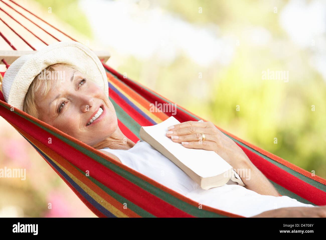 Senior Woman Relaxing In Hammock Stock Photo - Alamy