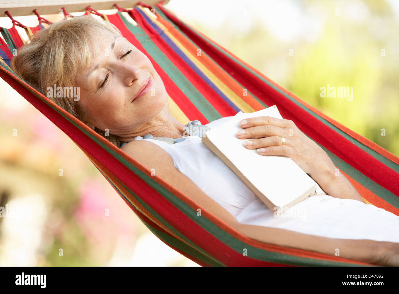 Senior Woman Relaxing In Hammock Stock Photo - Alamy