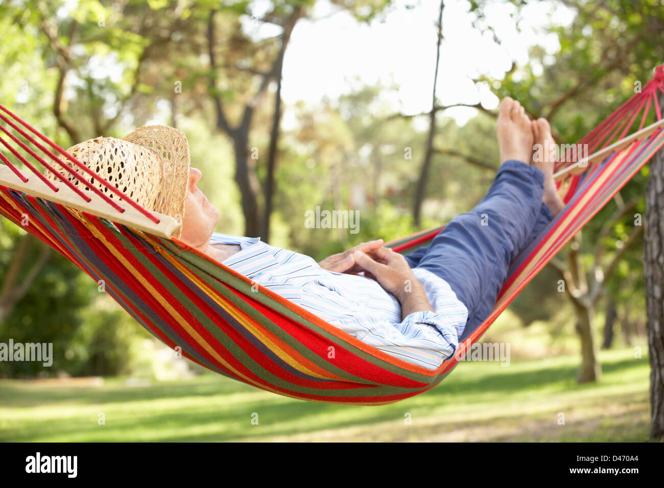 Senior Man Relaxing In Hammock Stock Photo