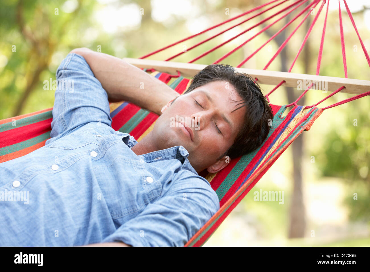 Mid adult man lying in hammock hi-res stock photography and images - Alamy