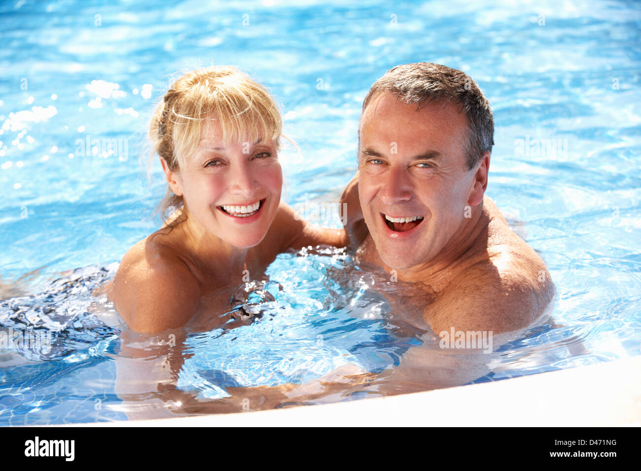 Senior Couple Having Fun In Swimming Pool Stock Photo - Alamy