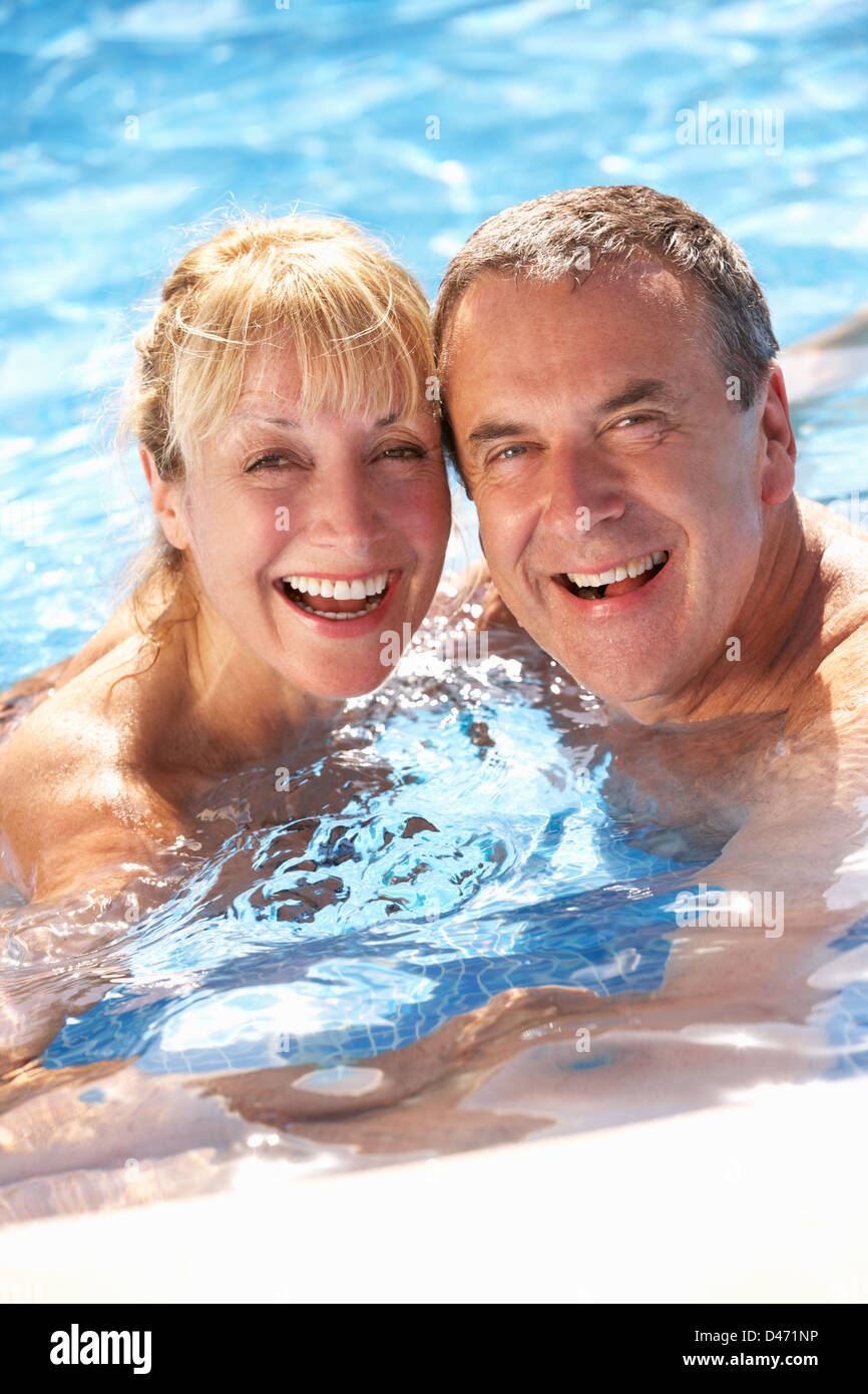 Senior Couple Having Fun In Swimming Pool Stock Photo - Alamy