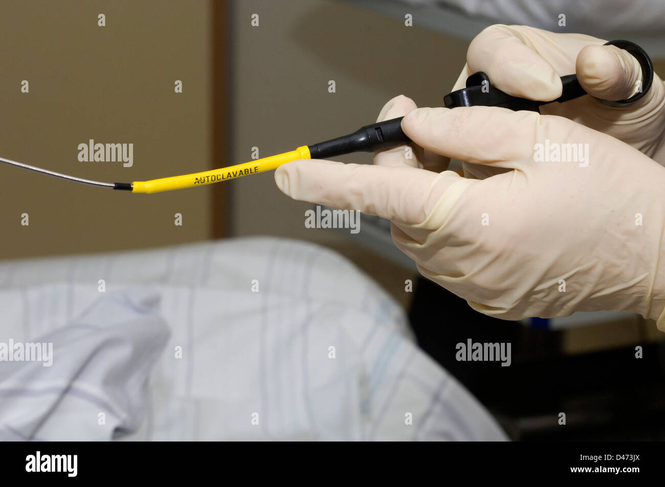 A surgeon prepares a needle to perform an aspiration biopsy under an