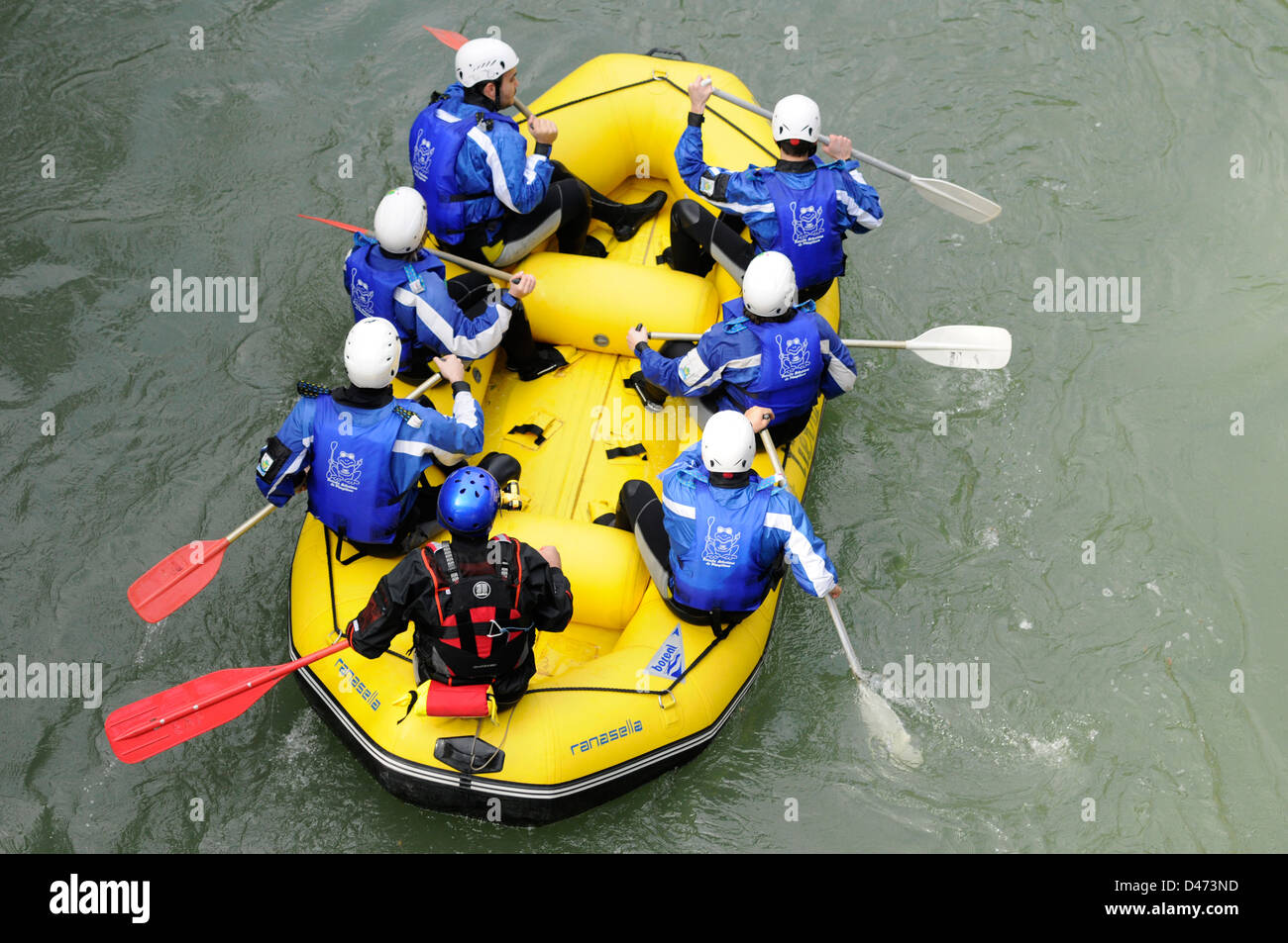 Young tourists practice rafting with a guide in Sella river in an inflatable boat in Asturias, Spain. Stock Photo