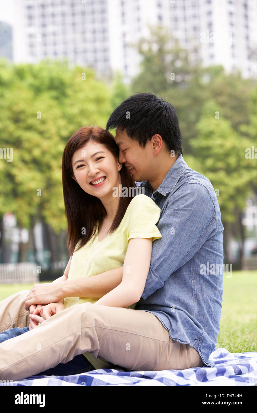 Young Chinese Couple Relaxing In Park Together Stock Photo - Alamy