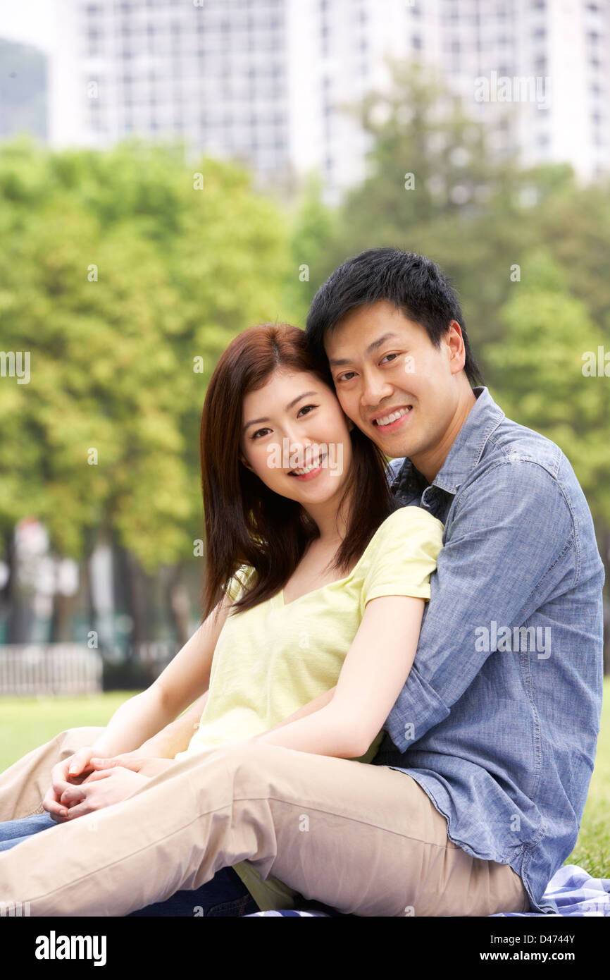 Young Chinese Couple Relaxing In Park Together Stock Photo - Alamy