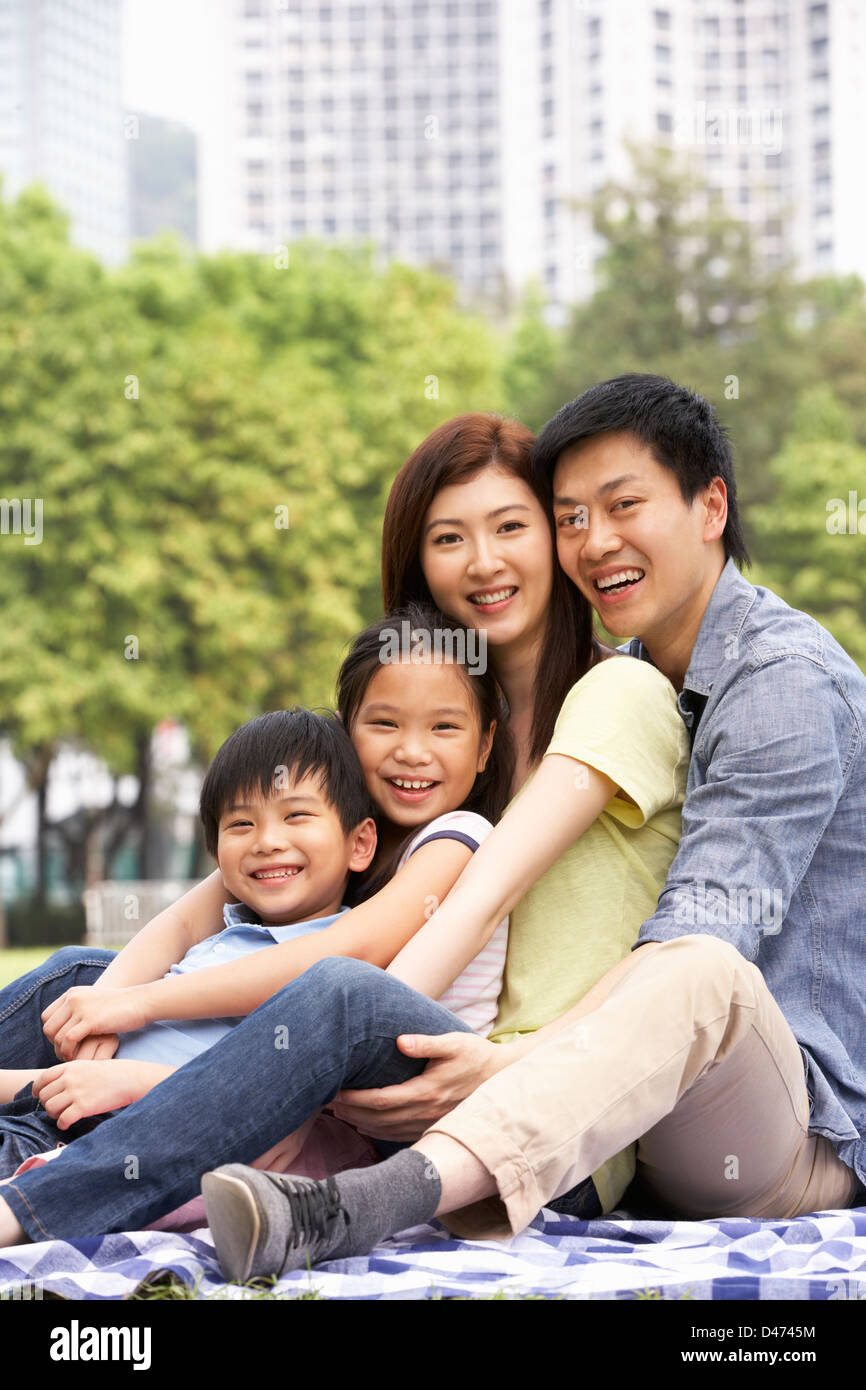 Young Chinese Family Relaxing In Park Together Stock Photo - Alamy