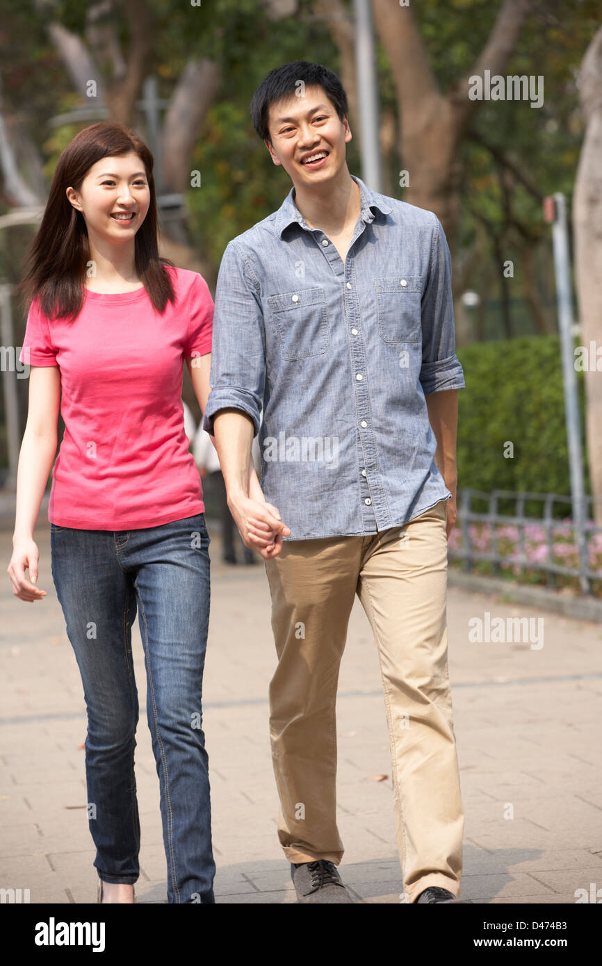 Young Chinese Couple Walking In Park Stock Photo - Alamy