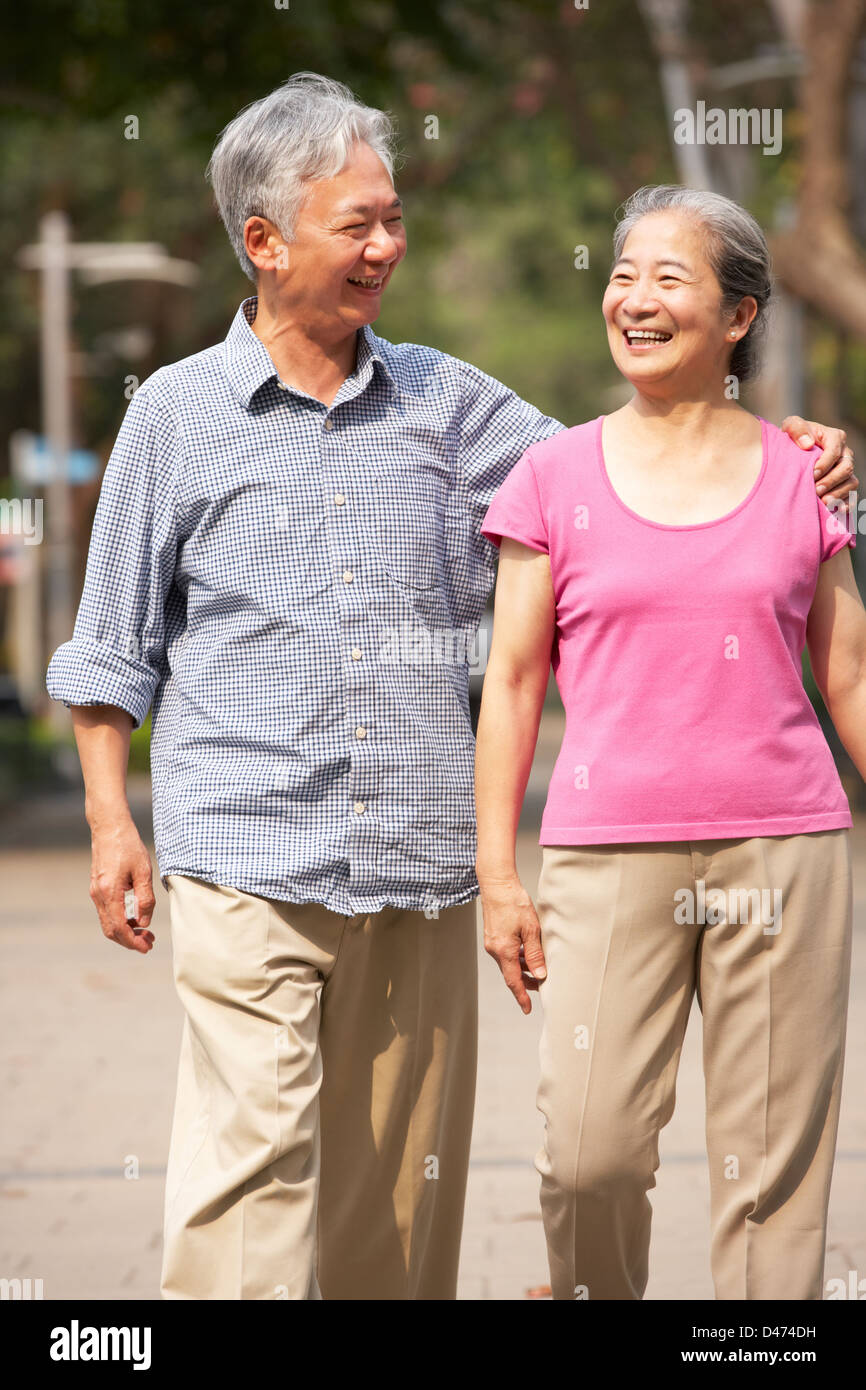 Senior Chinese Couple Walking In Park Stock Photo - Alamy