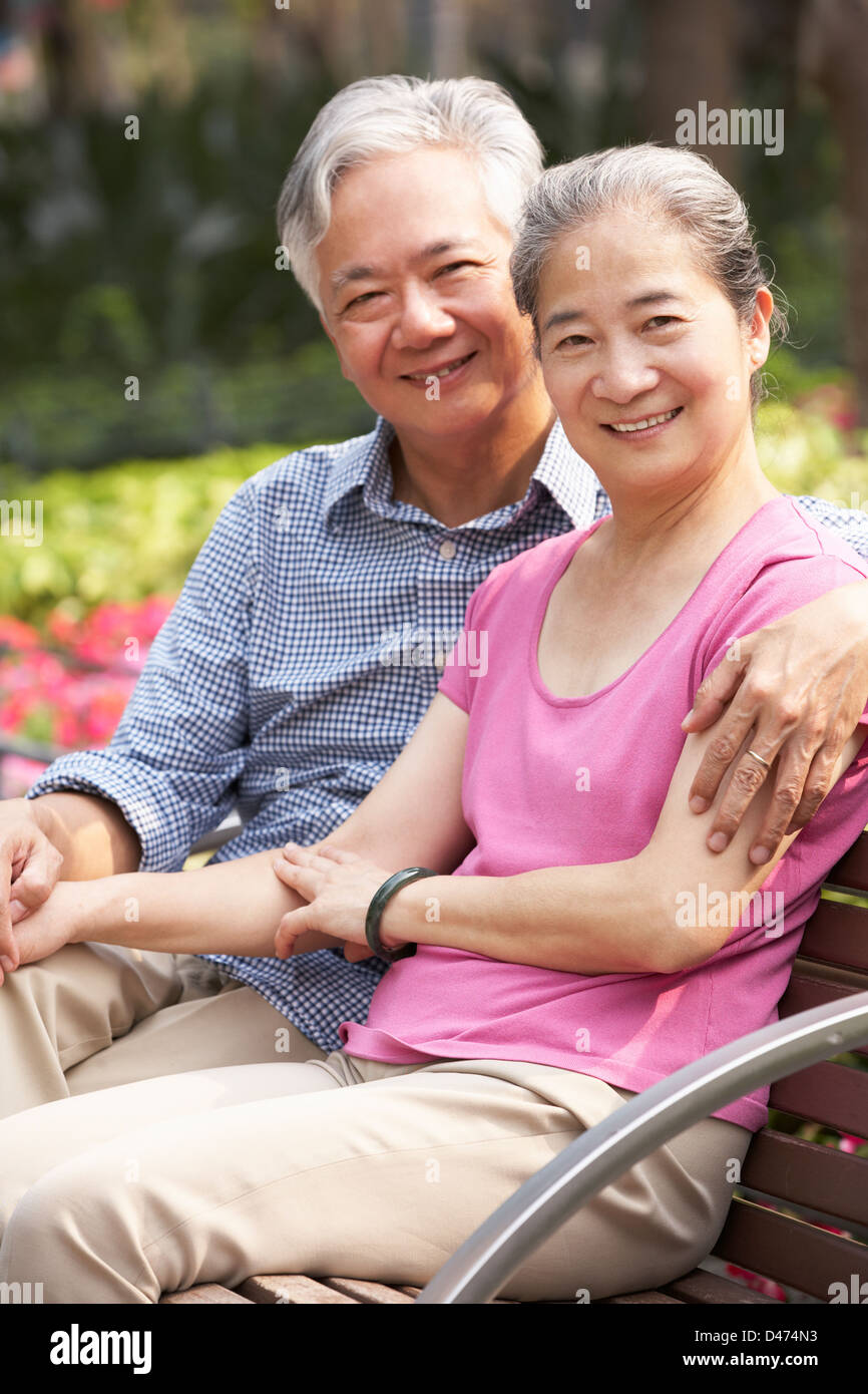 Senior Chinese Couple Relaxing On Park Bench Together Stock Photo - Alamy