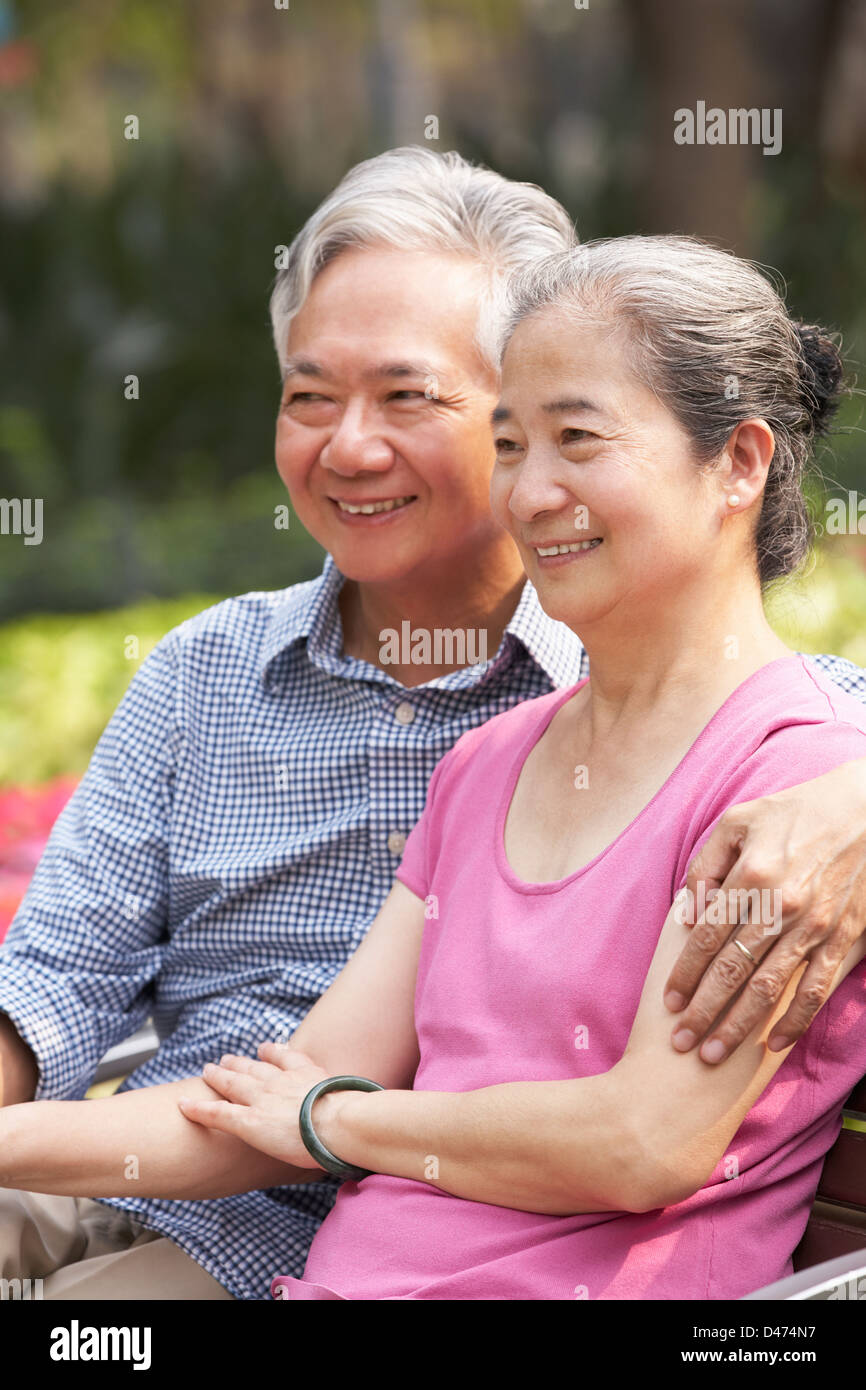 Senior Chinese Couple Relaxing On Park Bench Together Stock Photo - Alamy