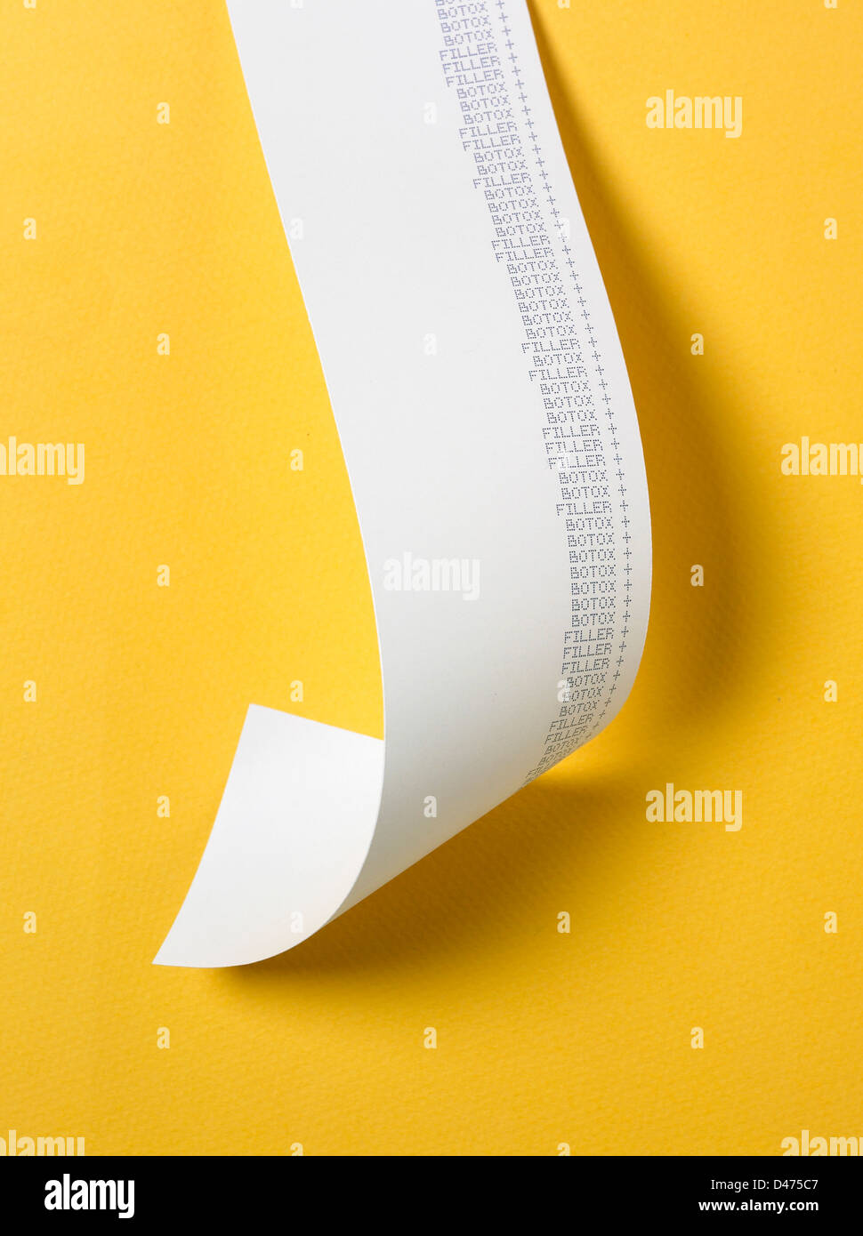 Strip of receipt cut out yellow background Stock Photo