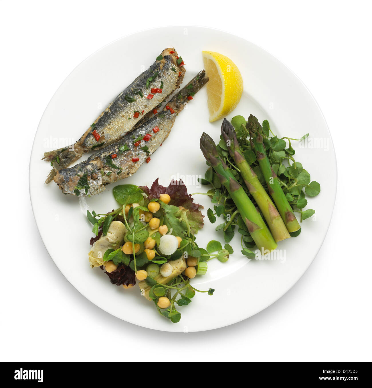 Plate of Fish lemon asparagus and salad Stock Photo