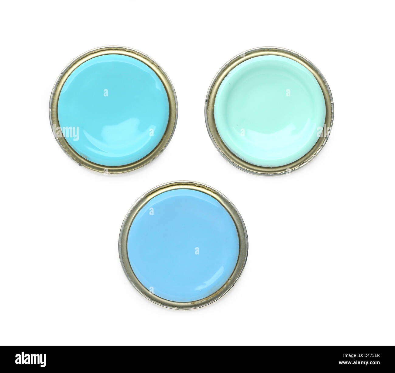 Three turquoise paint lids cut out white background Stock Photo