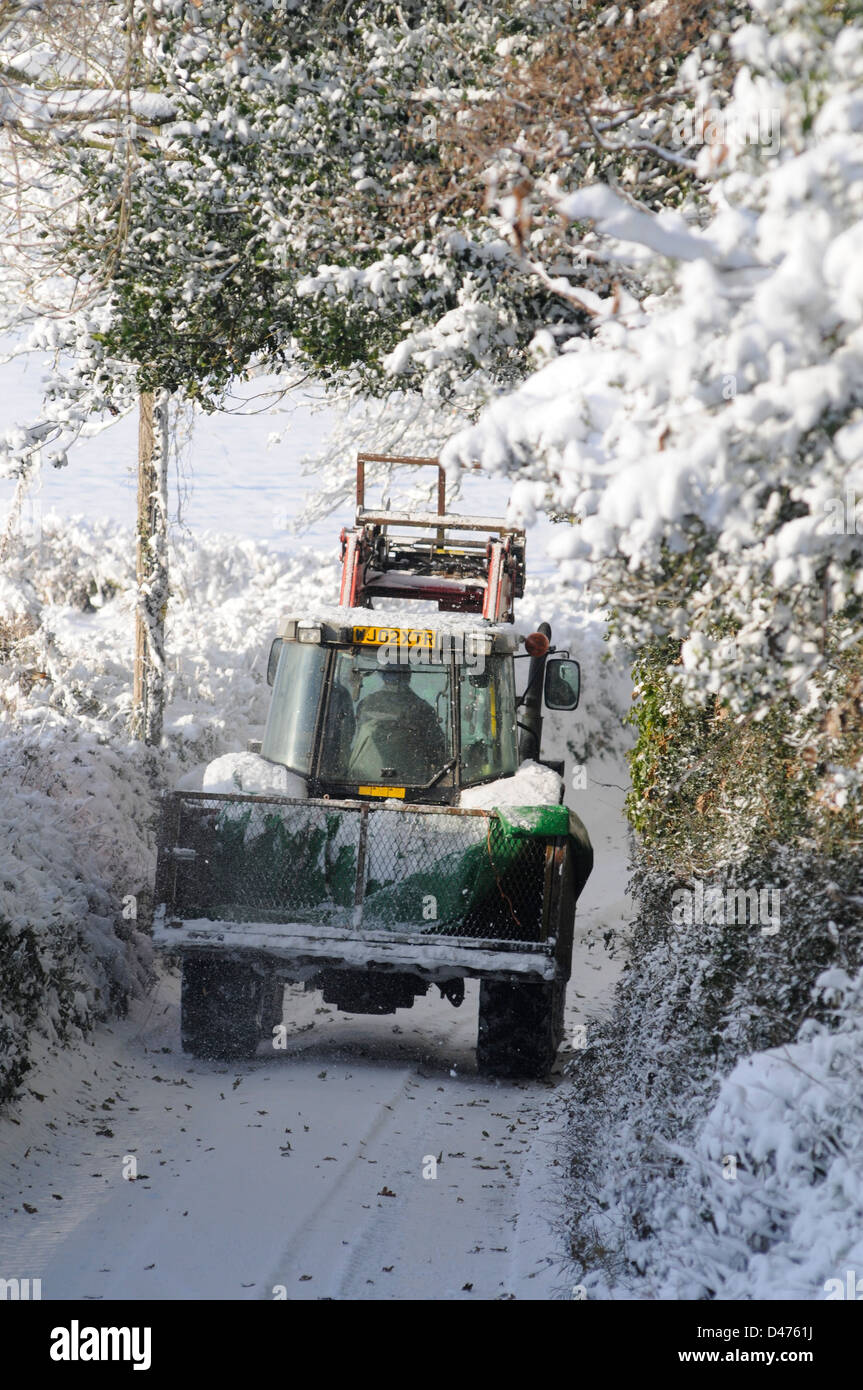 Farmers clearing the roads following heavy snowfall. Ottery St Mary, Devon, UK Stock Photo