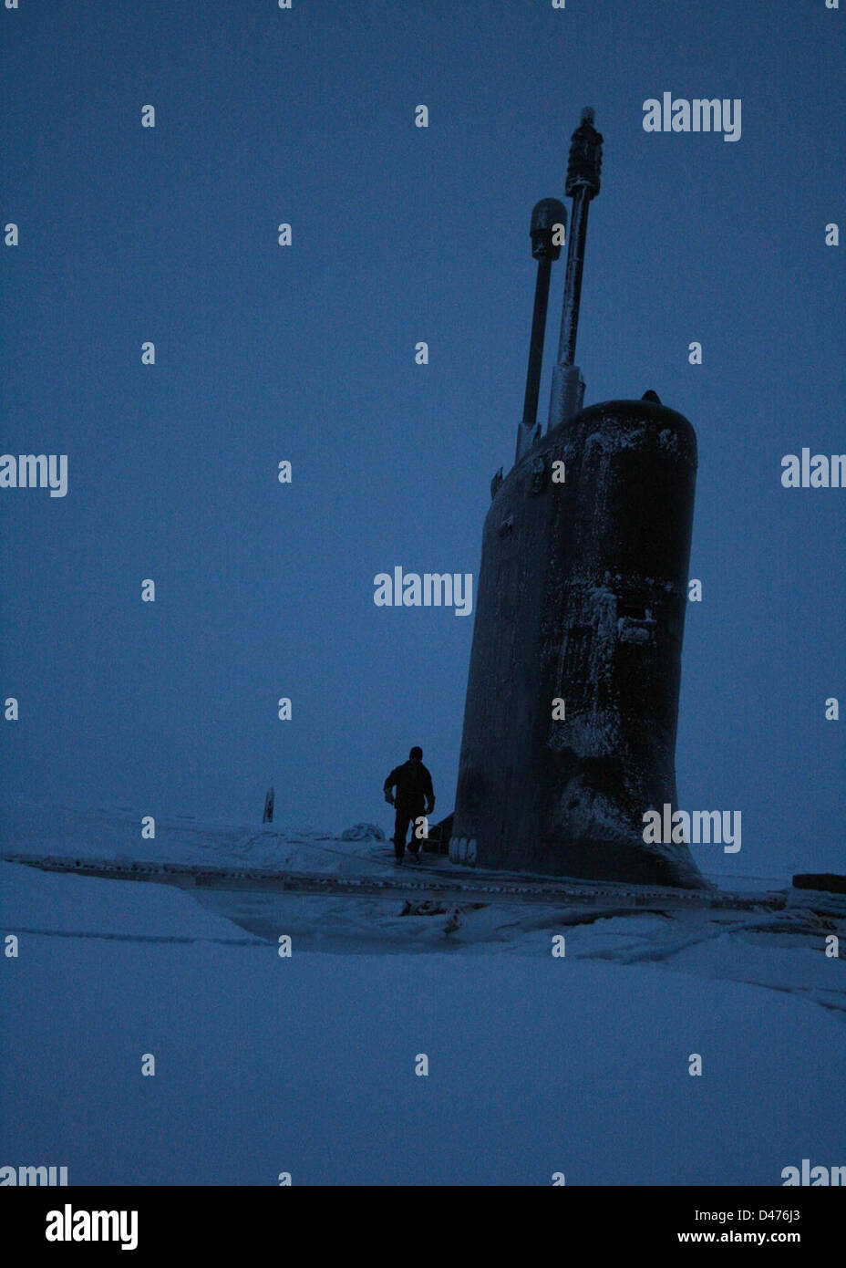 Sailor inspects deck of USS Texas after surfacing around North Pole. Stock Photo
