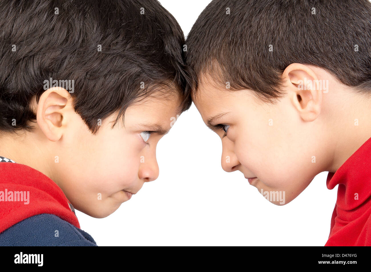 Two boys facing one another isolated in white Stock Photo