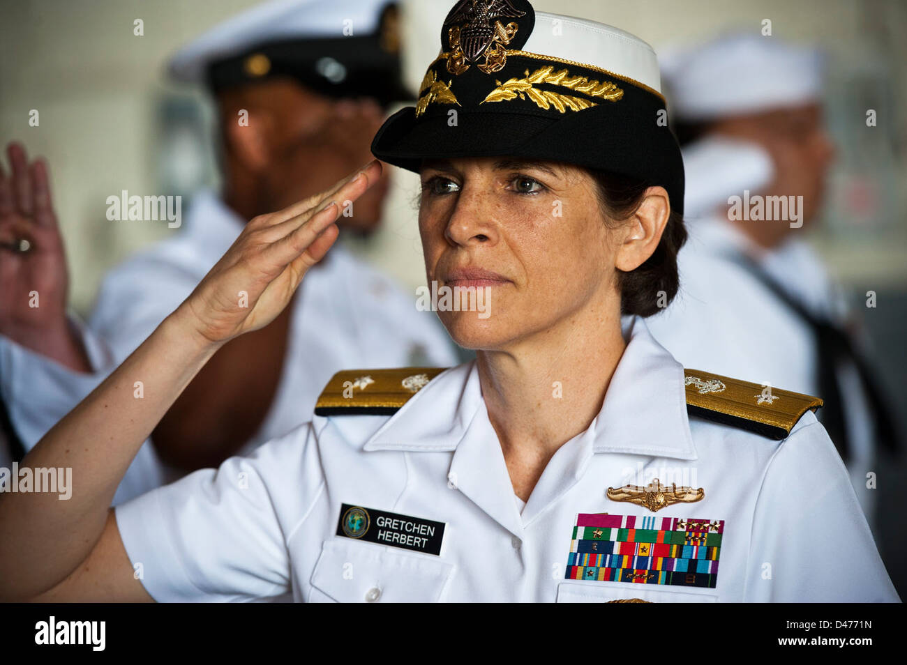 Admiral salutes as she is piped aboard during the Navy Cyber Forces change of command ceremony Stock Photo