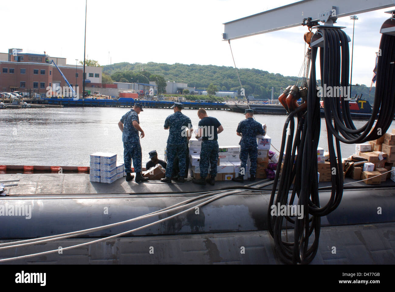 Sailors load stores onto USS Hartford. Stock Photo