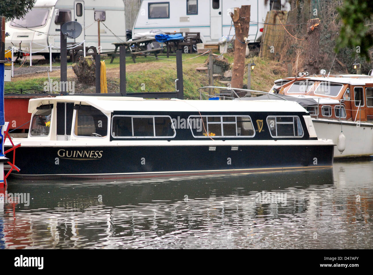 A narrow boat on the River Medway in Maidstone in Guinness livery Stock Photo Alamy