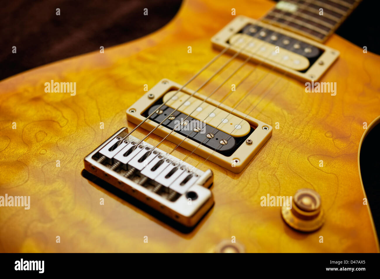 Exposed pickups on a quilted maple electric guitar. Stock Photo