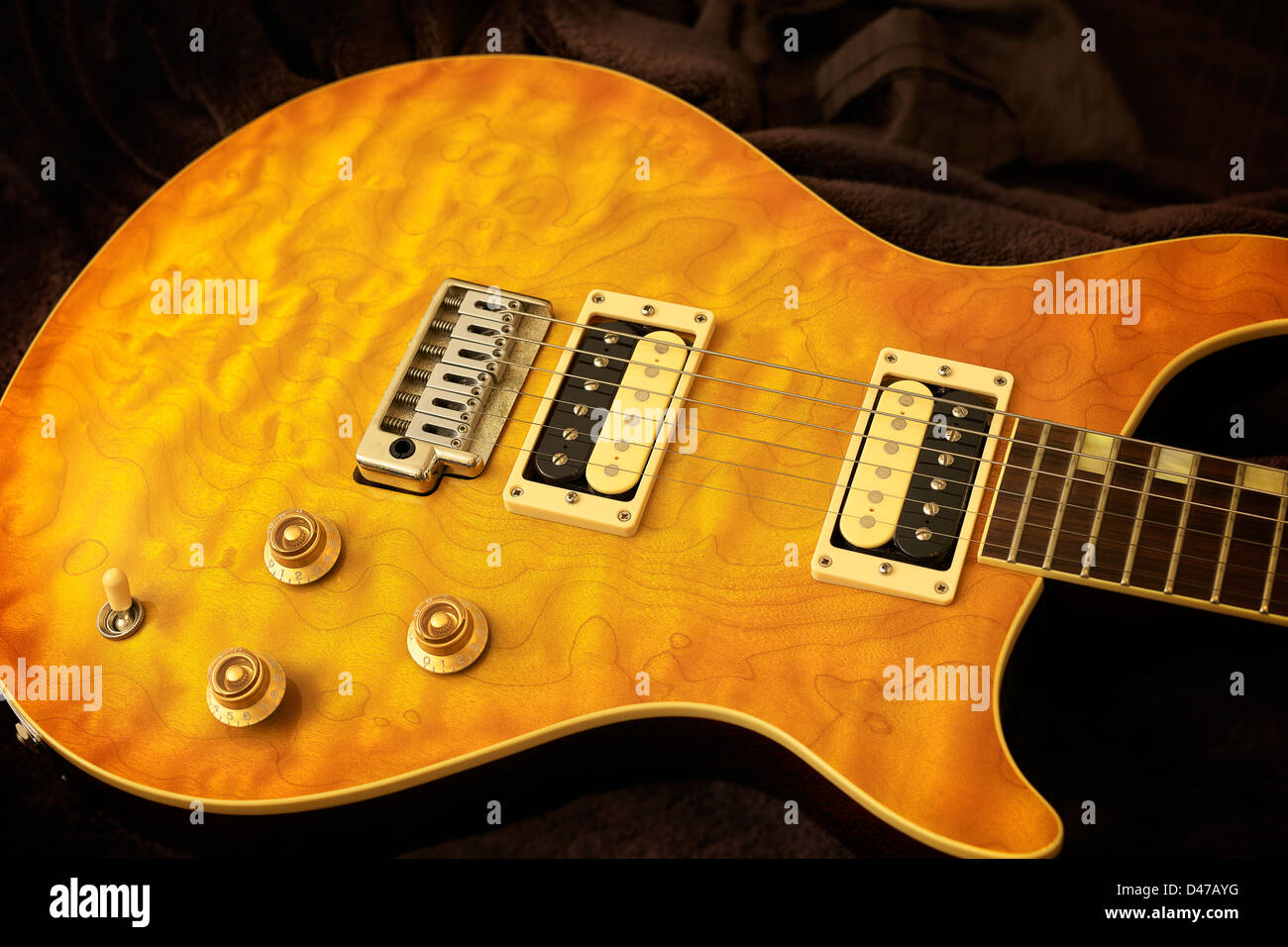 A finely figured, quilted maple guitar top. Stock Photo
