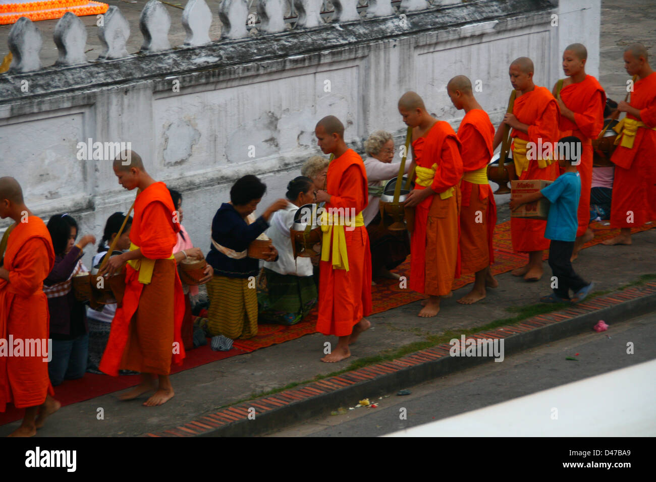 Monks processing at dawn for alms of rice in Luang Prabang, Laos, Indochina, Southeast Asia, Asia Stock Photo