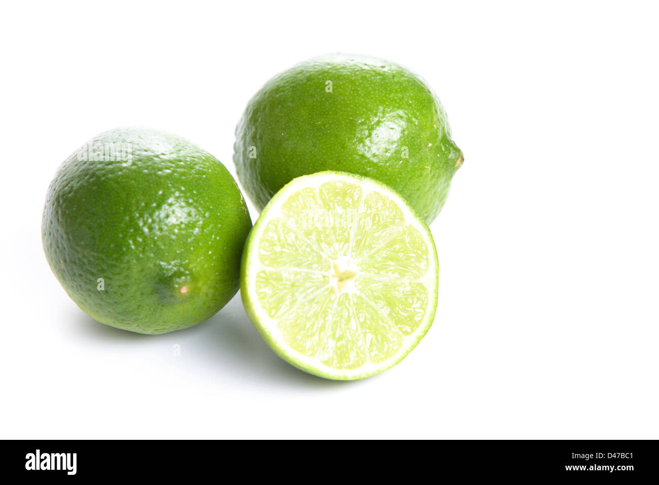 Limes cut in half isolated on white Stock Photo Alamy