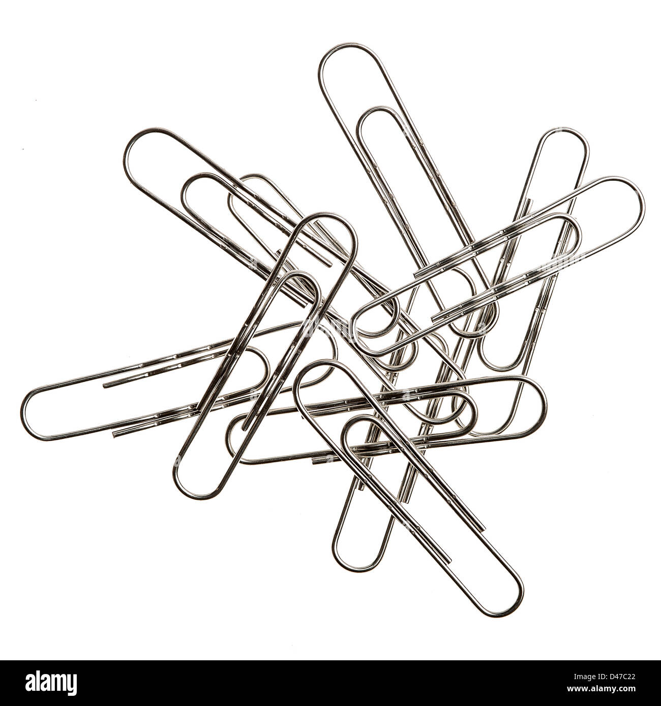 Small pile of large paper clips. Silver design on white background. Stock Photo
