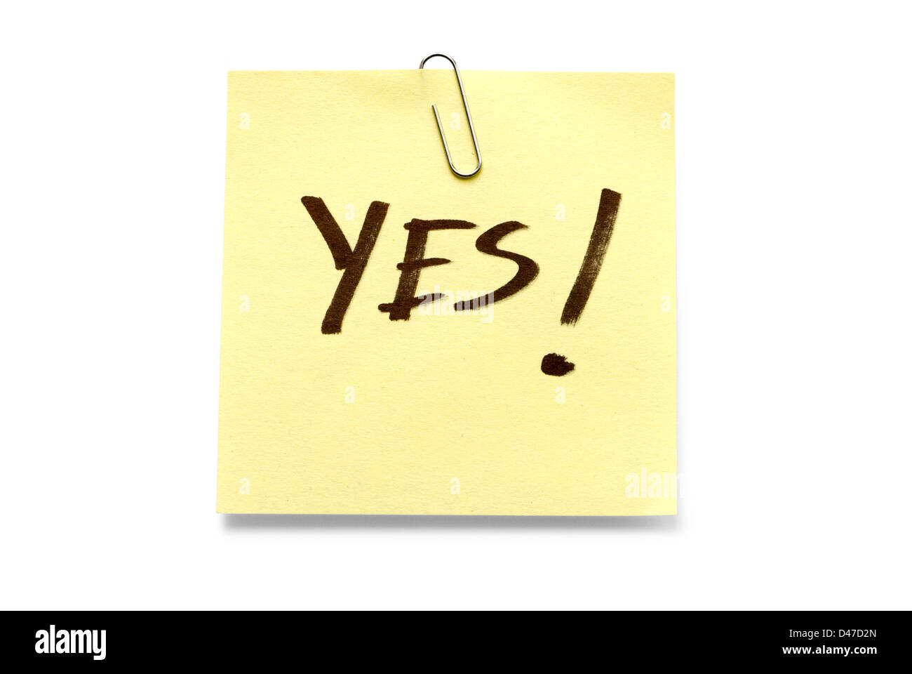 Adhesive note with 'Yes' written across it Stock Photo