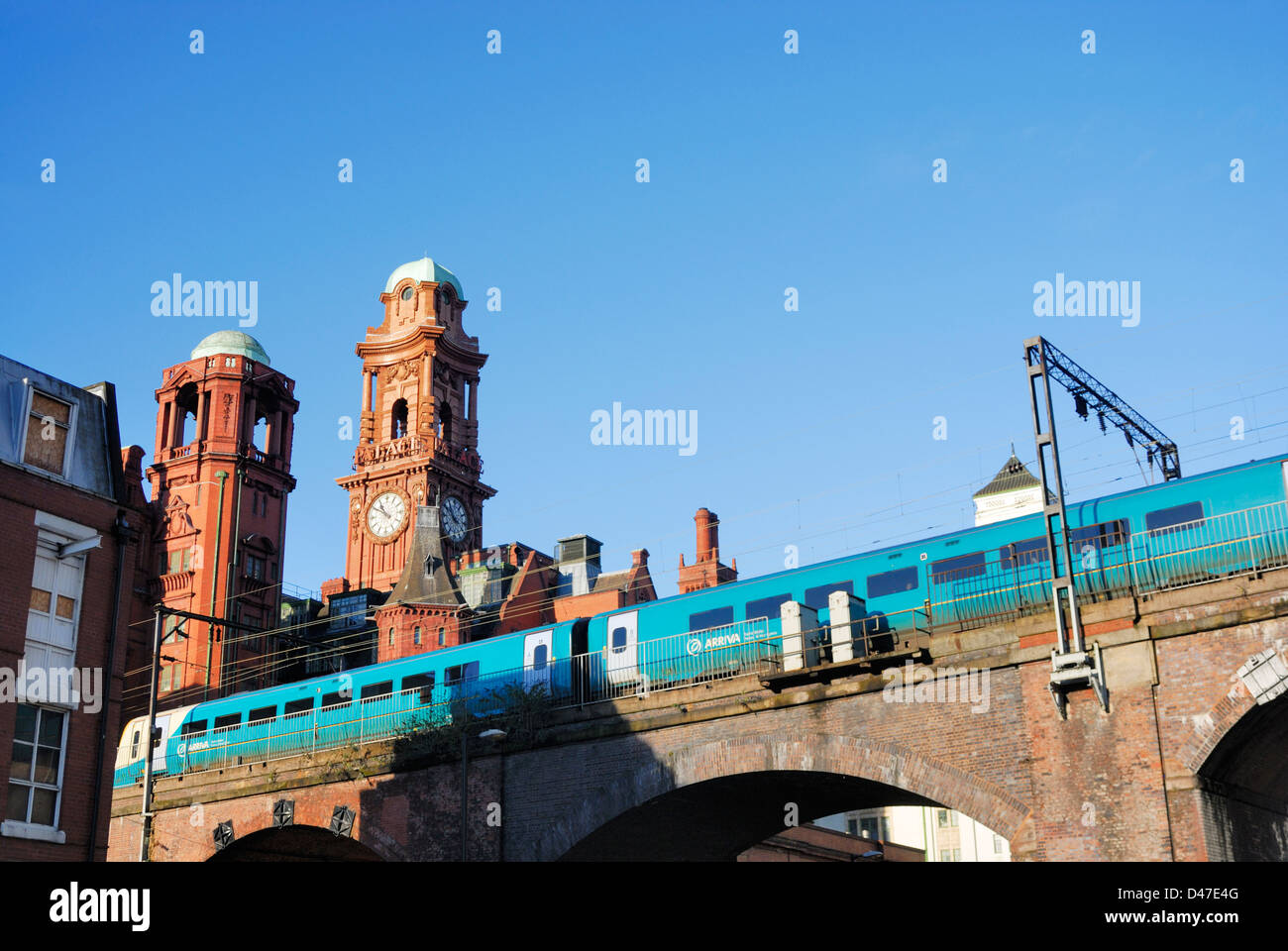 Commuter train passing through Manchester city centre by Oxford Road with the Refuge Building in the background. Stock Photo
