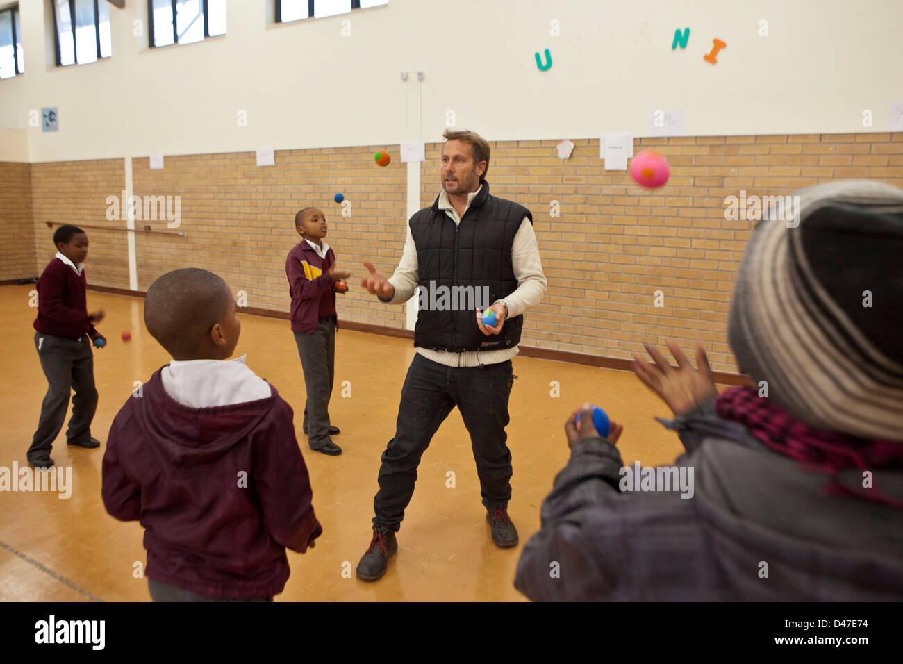 African school boys juggling balls as part of a circus class in hall of