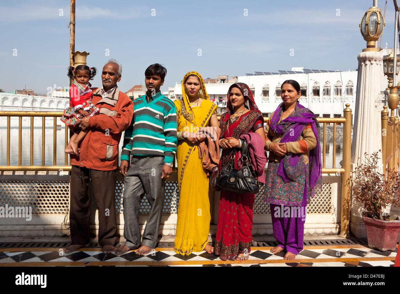 A Hindu family including a traditionally dressed bride visiting Shree  Durgiana temple in Amritsar, Punjab, India. Stock Photo