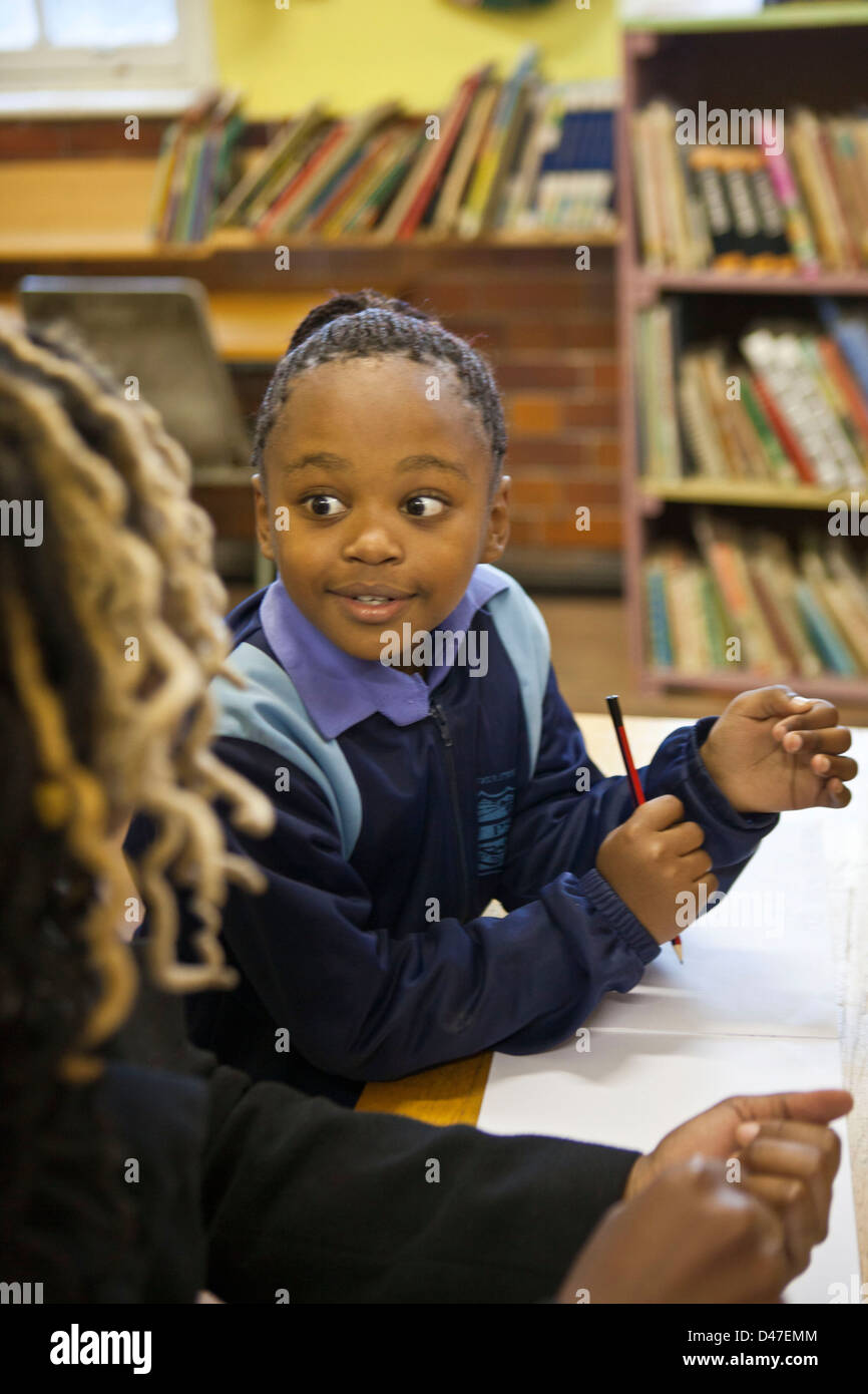 School child being helped by a volunteer teacher in reading / literacy class, Cape Town, South