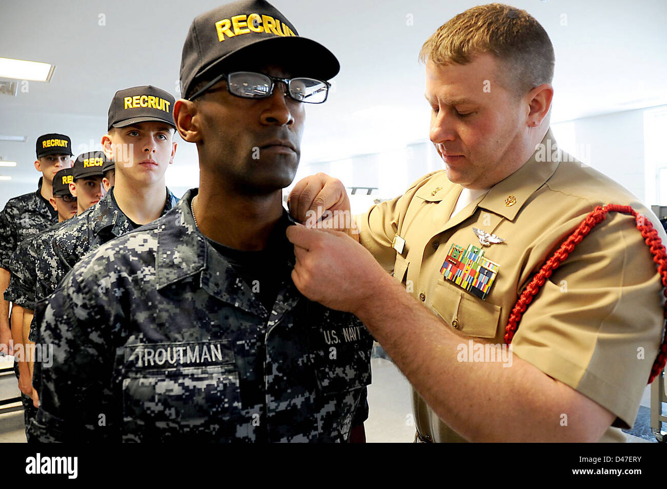 A recruit division commander inspects the uniform of a recruit at Recruit Training Command. Stock Photo